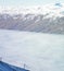 An empty chairlift with a backdrop of fog and mountains