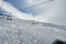 empty chairlifts slide above the slopes of skiing resort Hoch Ybrig in Switzerland