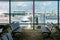 Empty chairs in the departure hall at airport with airplane parking. Travel and transportation in airport concepts