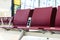 Empty chairs with electric outlet in airport waiting area near gate