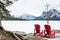 Empty Chairs on the shore of a frozen lake in the mountains