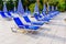 Empty chaise lounges and sun umbrellas near the swimming pool