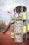 An empty children`s playground with playground equipment in the city park, fenced with warning tapes in red and white