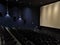 Empty cinema hall with dark chairs