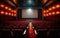 Empty cinema theater with red seats curtains and a blank white screen ready for the audience to enjoy a movie