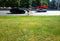 Empty city road with mixed traffic and green grass background