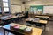 empty classroom setup with books, notebooks, and pens on the desks for students to explore learning