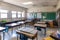 empty classroom setup with books, notebooks, and pens on the desks for students to explore learning