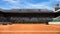 Empty clay tennis court with spectators 3d render