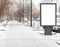 Empty clean white Billboard on a city street. Snow is falling