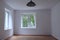 Empty clear room with window overlooking forest