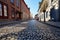 empty cobblestone street with building shadows