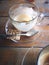 Empty coffee cup with cookies on wooden table in cafe