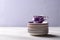 Empty colorful porcelain tableware. Violet cup with plates on lilac background