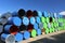 Empty colourful metal drums used for transport of liquids at a yard of a factory