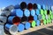 Empty colourful metal drums at a yard of a factory