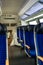 Empty commuter train car with soft blue seats