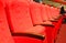 Empty concert hall, theater chairs background ... color photo, empty cinema or concert hall. The red chairs in the