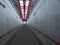 Empty concrete undergound passage platform subway on train station, gray and red, diminishing perspective