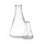 Empty conical flasks on white background