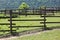 Empty corral against greeny mountain summertime