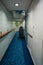 Empty corridor of a ship with a stroller outside a cabin