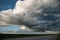 Empty country asphalt road with dramatic voluminous evening clouds before a thunderstorm. Beautiful weather clouds