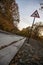 Empty countryside road, sign curves on the way in autumn season