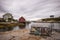 An empty crab cage in the foreground, houses in the background found in Peggy`s Cove in Halifax Nova Scotia