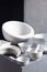 Empty crockery or ceramic dishes set. Kitchen dishware and tableware on grey near wall background