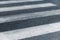 Empty crosswalk in gray and white. Pedestrian crossing, asphalt road.