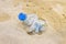 Empty crumpled plastic bottle of water abandoned on the beach