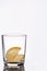 Empty crystal glass with reflection on white isolated background with two pieces of lemon