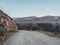 Empty dangerous narrow cliffside  mountain road. Dangerous off road driving along mountain edge and steep cliff