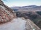 Empty dangerous narrow cliffside  mountain road. Dangerous off road driving along mountain edge and steep cliff