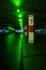 empty dark parking garage with green lights at the top