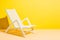 Empty deck chair on yellow background. Sunbed, studio shot. Beach tourism, travel, relax, vacai, holiday background. Minimal