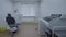 Empty dentistry room equipped with blue dental unit, furniture, operating lamp