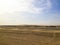 Empty desert area in Sealine, Qatar showing empty road with no people and sand dunes only.