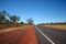 Empty desert road in outback Australia with Baobab tree