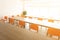 Empty desks and chairs in high key cafeteria room