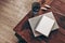 Empty diary, notepad mockup and book on wooden table. Glass of water and dry Lagurus ovatus grass. Blurred beige jute