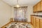 Empty dining room interior with window curtain, colorful rug