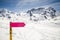 Empty directional sign post with winter snow mountain landscape.