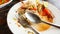 Empty dirty plate seafood paste on wooden table left after lunch