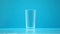 Empty drinking cup, glass for milk and water on blue background, zero calorie