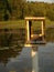 Empty duck house in the center of a lake,