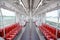 Empty elevated train coach with red seats