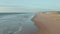 Empty Endless Beach with Dunes and Blue Ocean, Aerial high angle forward into the distance in California