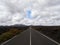 Empty endless highway through the volcanic landscape of Lanzarote